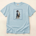 Light blue t-shirt with a cat playing saxophone design on a beige background